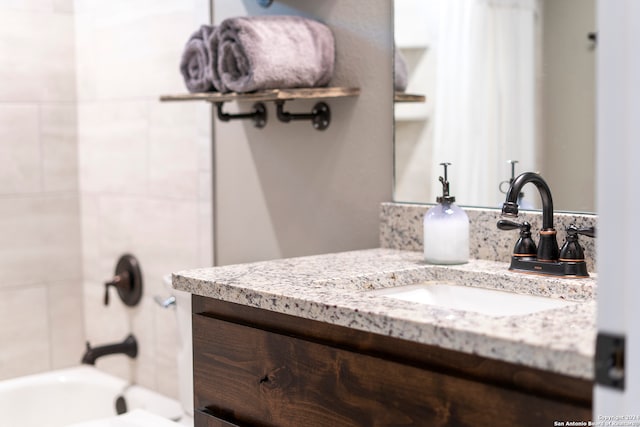 bathroom featuring vanity and tiled shower / bath combo