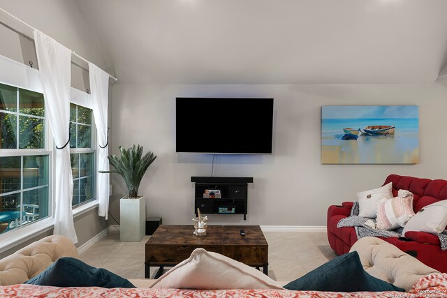 tiled living room with a wealth of natural light and vaulted ceiling