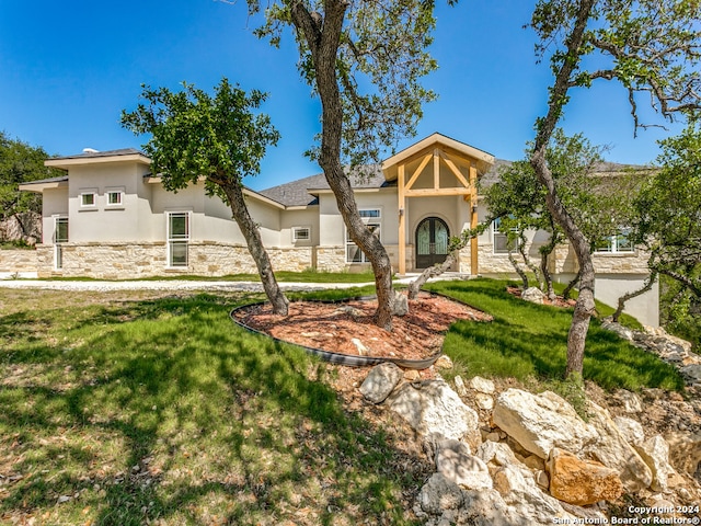 mediterranean / spanish-style home with a front lawn