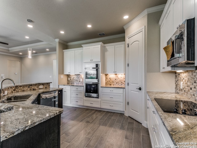 kitchen with sink, appliances with stainless steel finishes, tasteful backsplash, white cabinets, and hardwood / wood-style floors