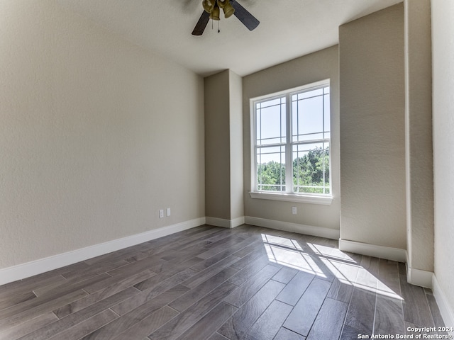 spare room featuring dark hardwood / wood-style floors and ceiling fan