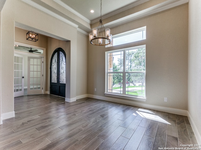 foyer with ceiling fan with notable chandelier, french doors, hardwood / wood-style flooring, and ornamental molding