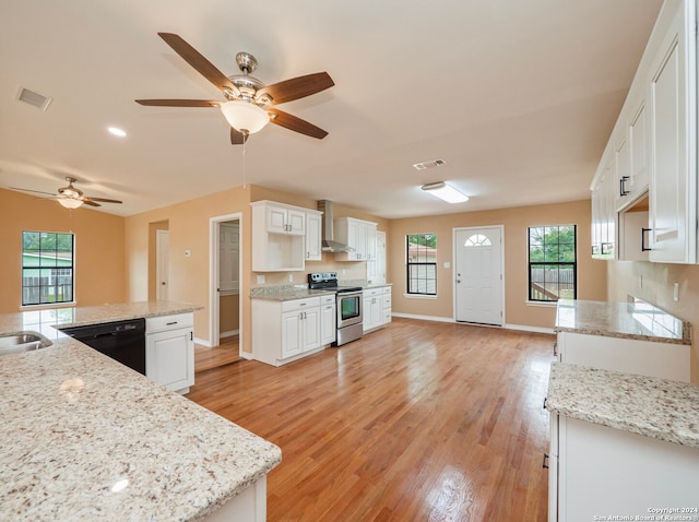 kitchen featuring wall chimney exhaust hood, light hardwood / wood-style flooring, white cabinetry, electric range, and dishwasher