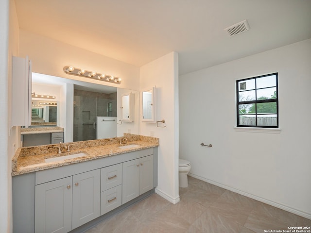 bathroom with large vanity, toilet, double sink, and tile flooring