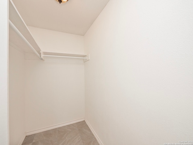 spacious closet with tile flooring