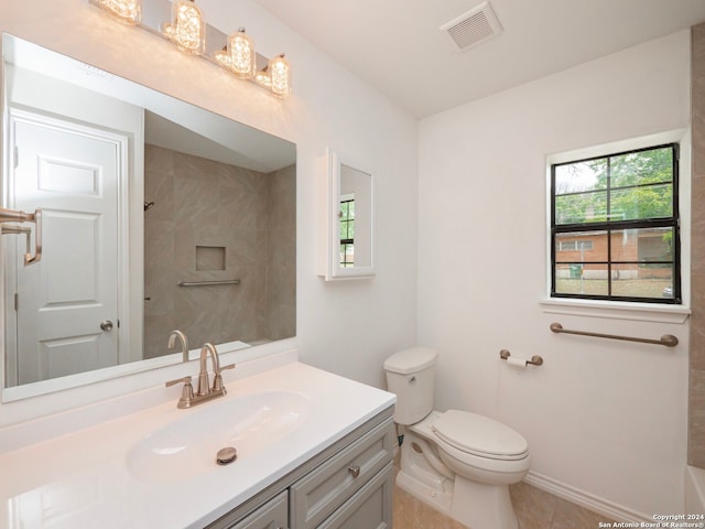 bathroom featuring vanity, tile floors, and toilet