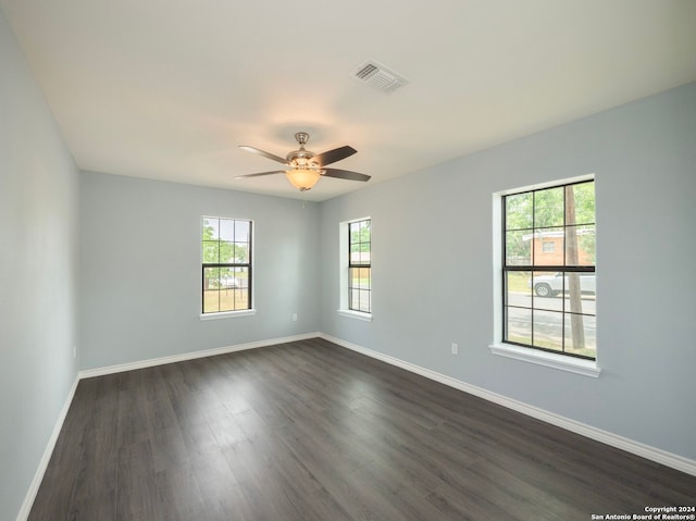 empty room with dark hardwood / wood-style floors and ceiling fan