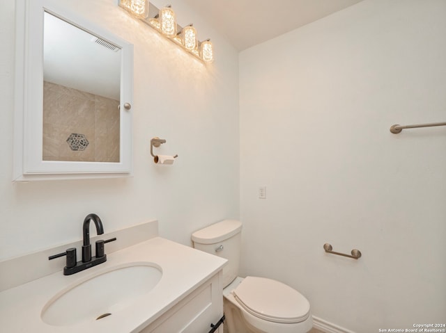 bathroom featuring toilet and vanity