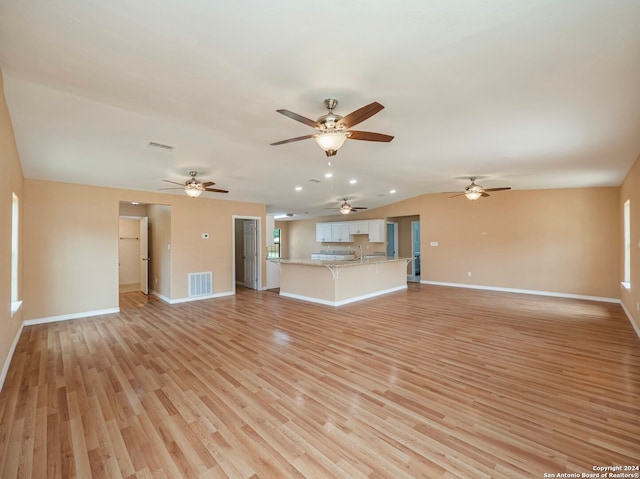 unfurnished living room featuring light hardwood / wood-style flooring and ceiling fan