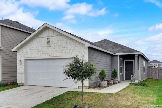 view of front of property featuring a front yard and a garage