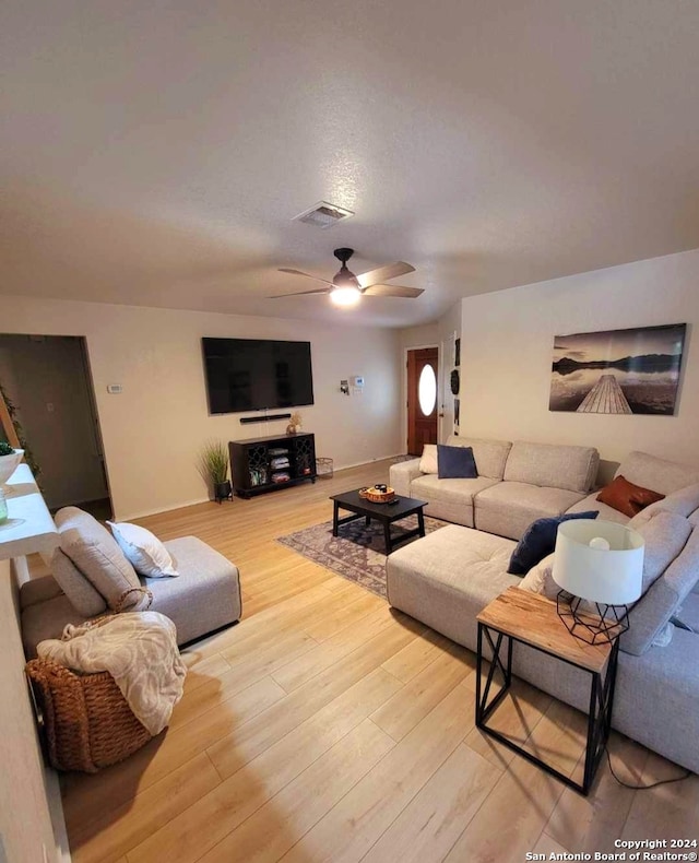 living room with ceiling fan and hardwood / wood-style flooring