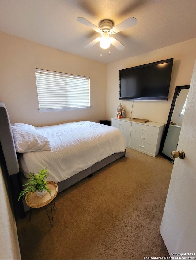 bedroom with light colored carpet and ceiling fan