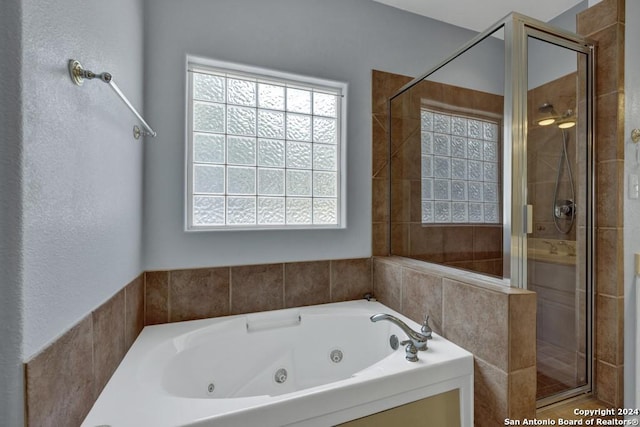 bathroom featuring independent shower and bath