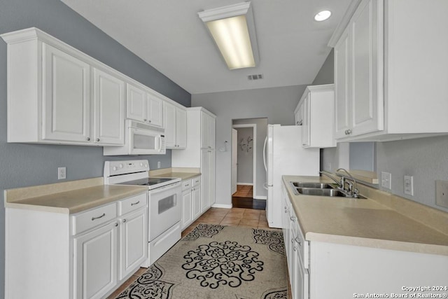 kitchen featuring white appliances, light wood-type flooring, sink, and white cabinetry