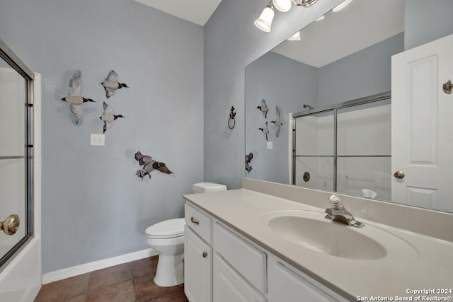 full bathroom with combined bath / shower with glass door, tile floors, oversized vanity, and toilet