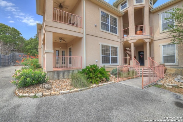 view of front of house featuring a balcony and ceiling fan