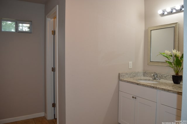 bathroom featuring tile floors and vanity