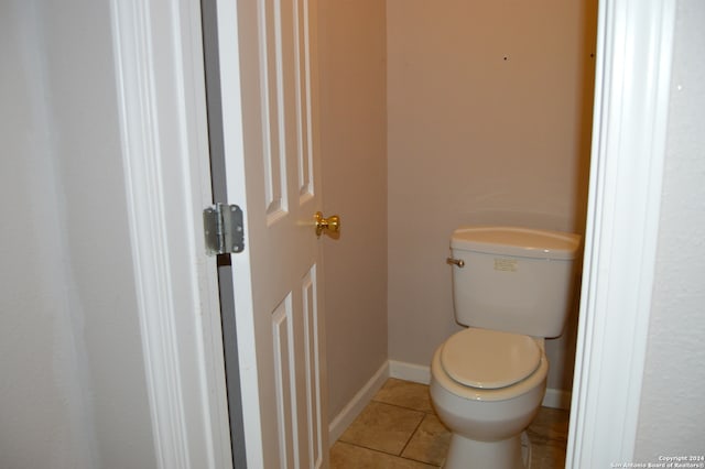 bathroom featuring toilet and tile floors