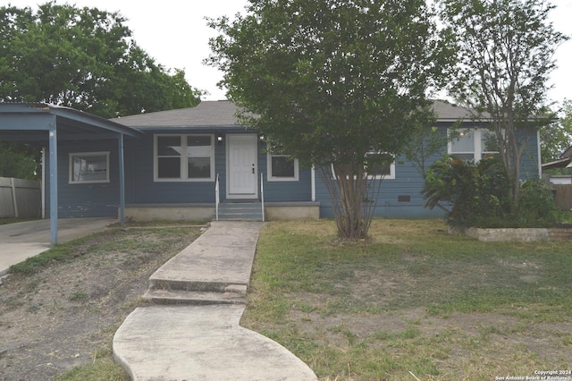 view of front of property featuring a front yard and a carport