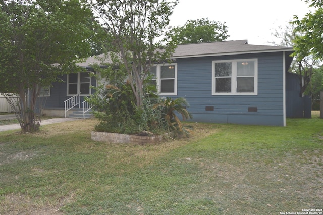 rear view of property with a yard