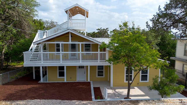 view of front of house featuring a patio area and a balcony