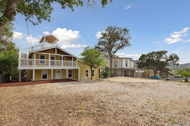 back of house featuring a balcony