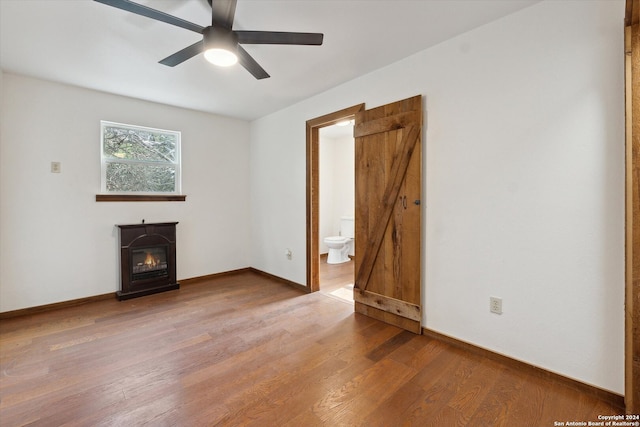 unfurnished living room featuring a fireplace, ceiling fan, and hardwood / wood-style flooring