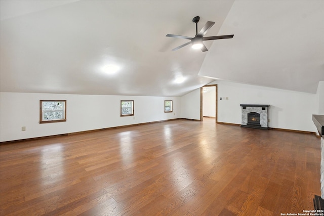 additional living space featuring hardwood / wood-style flooring, ceiling fan, and lofted ceiling