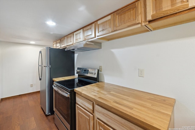 kitchen with dark hardwood / wood-style flooring, light brown cabinets, and electric stove