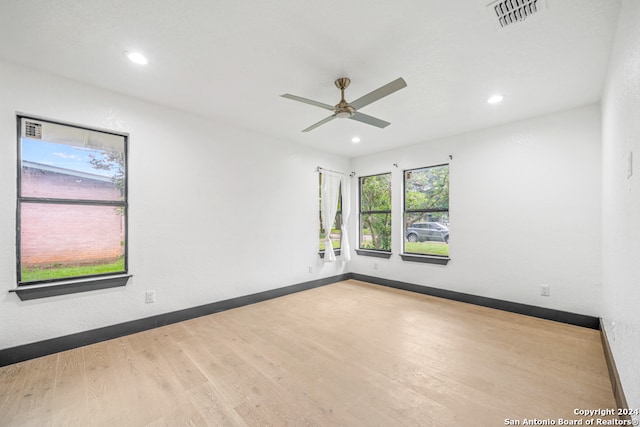 spare room featuring ceiling fan and light wood-type flooring