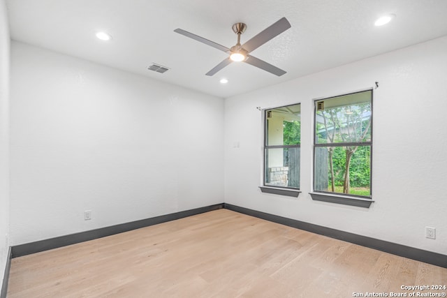 spare room with ceiling fan and hardwood / wood-style flooring