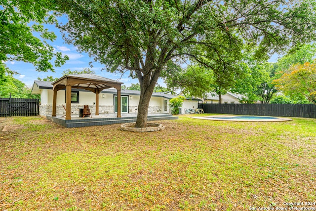 view of yard with a fenced in pool, a patio area, and a gazebo