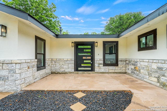 doorway to property featuring a patio