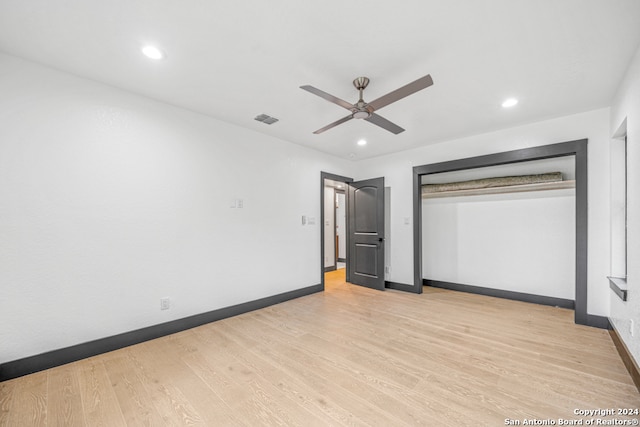 spare room featuring light hardwood / wood-style floors and ceiling fan