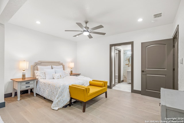 bedroom featuring light hardwood / wood-style flooring, ceiling fan, and ensuite bathroom