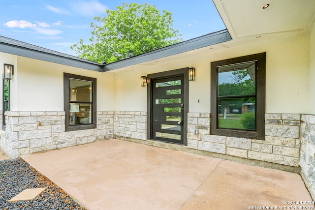 property entrance featuring a patio area