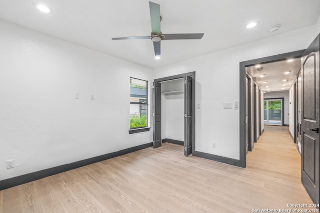 spare room with ceiling fan and light wood-type flooring