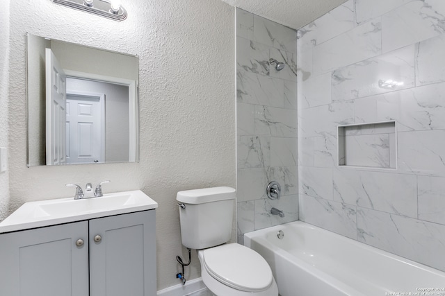 full bathroom with tiled shower / bath, vanity, toilet, and a textured ceiling