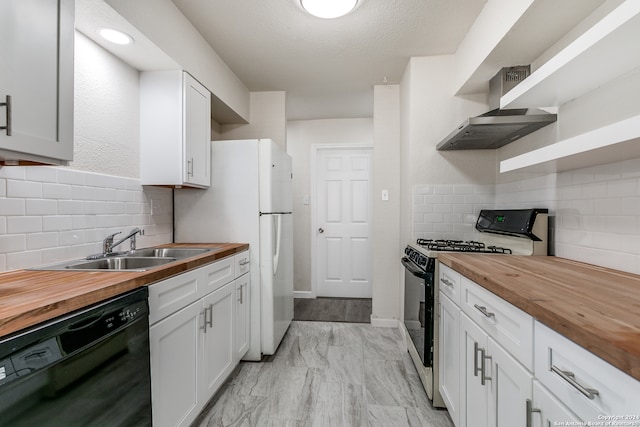 kitchen featuring wall chimney exhaust hood, black dishwasher, butcher block counters, and stainless steel gas range oven