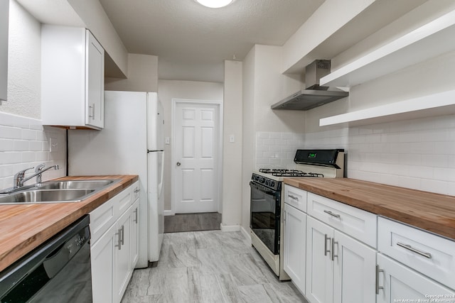 kitchen with stainless steel range with gas stovetop, sink, backsplash, wall chimney range hood, and butcher block counters