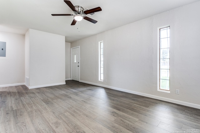 empty room with ceiling fan and hardwood / wood-style flooring