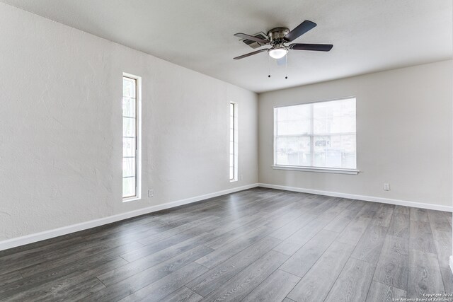 unfurnished room with wood-type flooring and ceiling fan