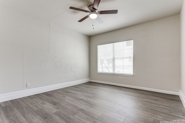 unfurnished room with ceiling fan and hardwood / wood-style flooring