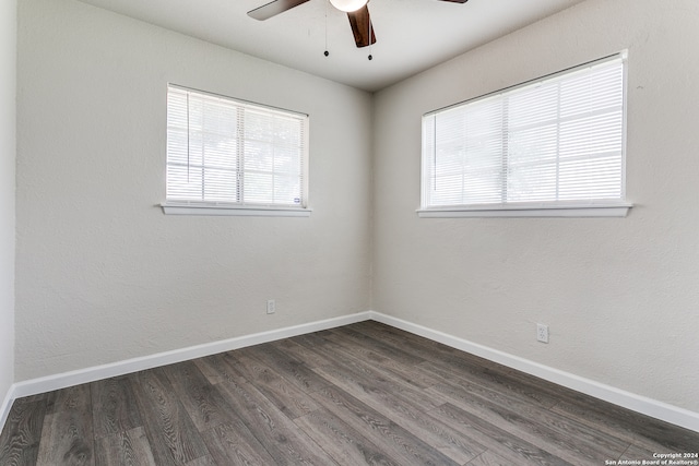 empty room with ceiling fan and dark wood-type flooring