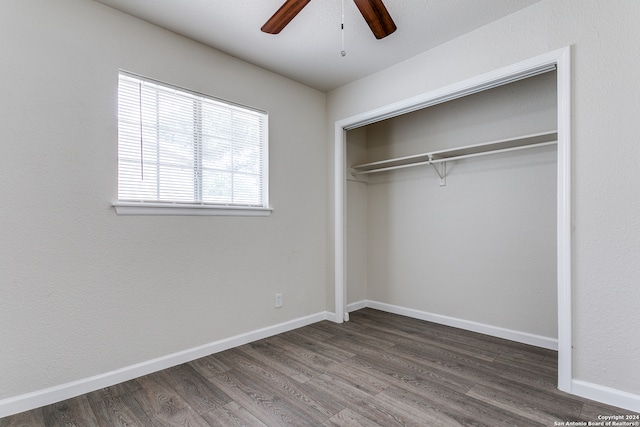 unfurnished bedroom featuring a closet, ceiling fan, and dark hardwood / wood-style floors