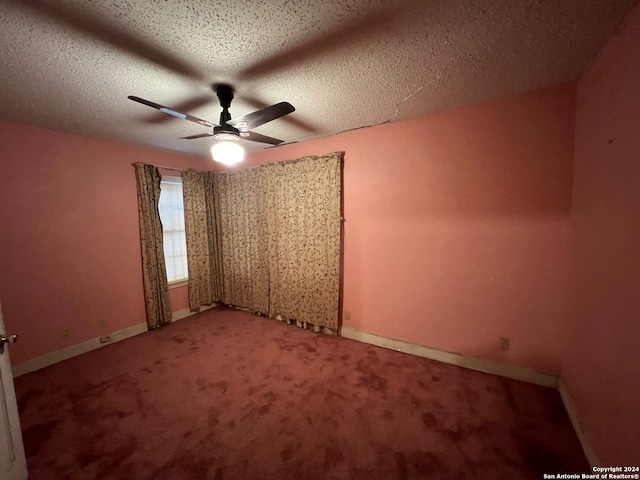 spare room with a textured ceiling, ceiling fan, and carpet flooring