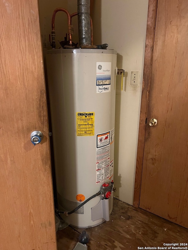 utility room featuring water heater