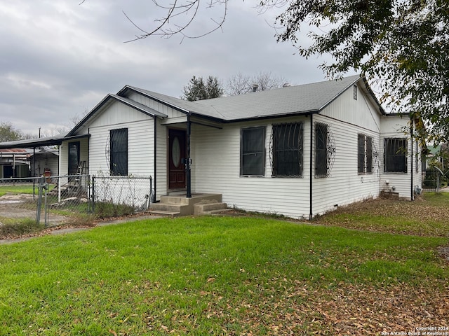 view of front facade with a carport and a front lawn