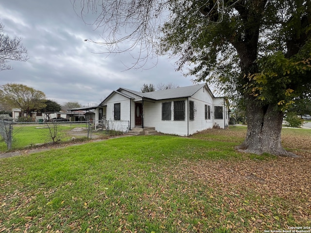 rear view of house featuring a yard