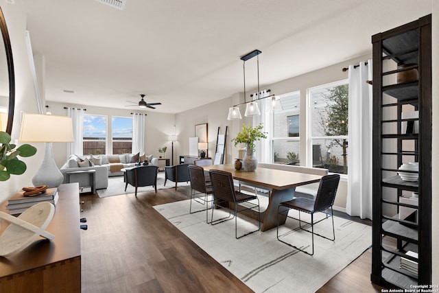 dining area with hardwood / wood-style floors and ceiling fan